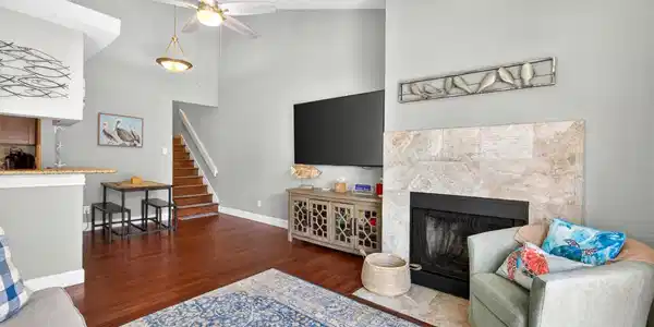 Image 4: The beautifully designed fireplace adds warmth and
