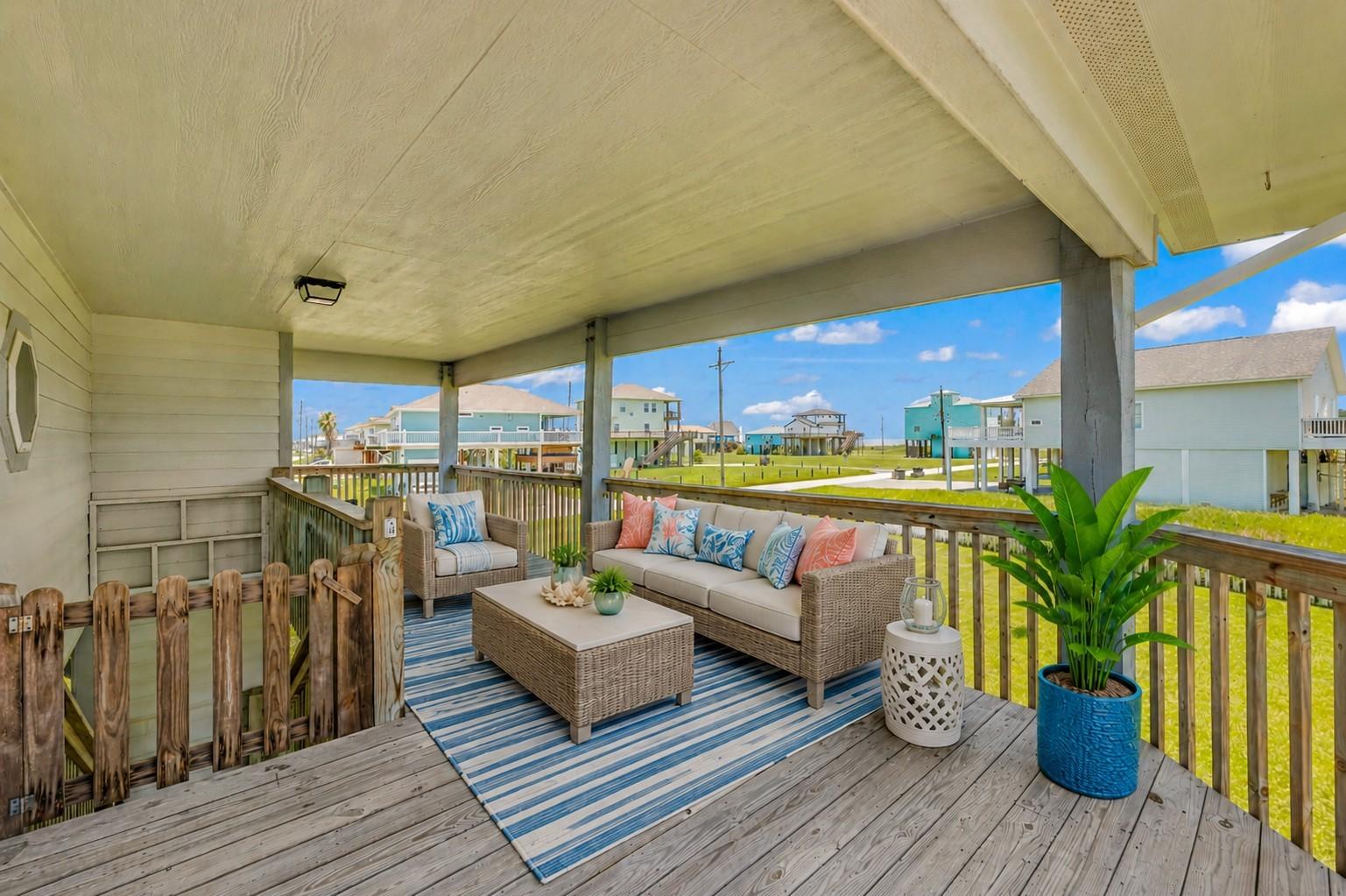 Image 2: The covered wooden deck provides a shaded outdoor