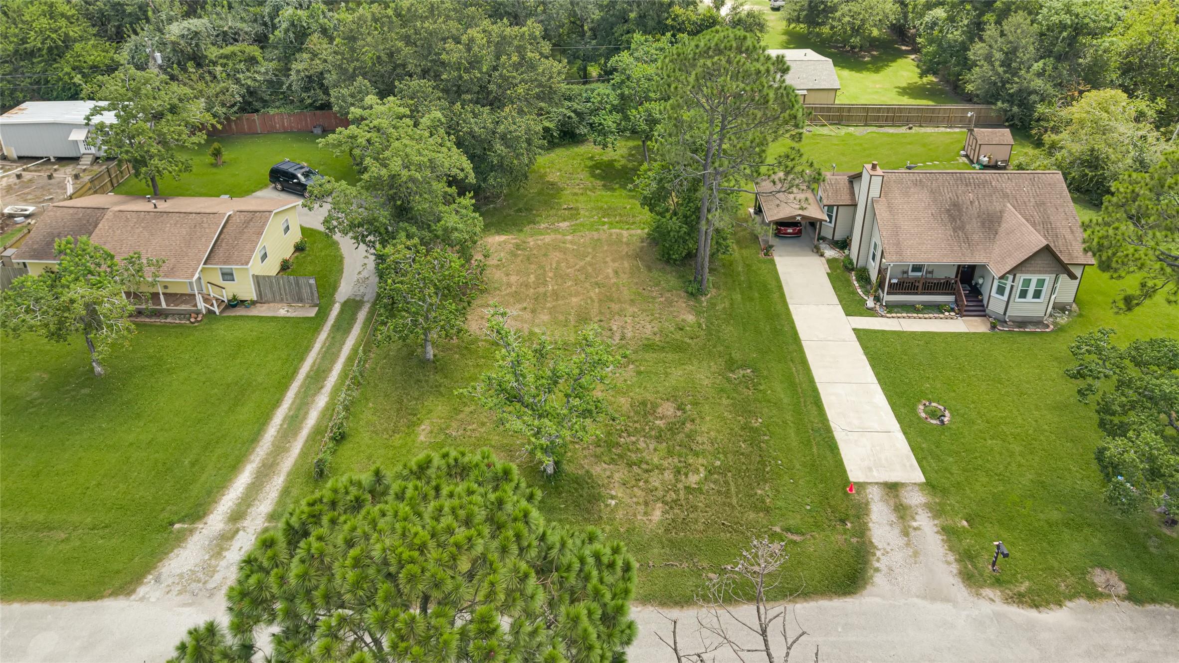 Image 1: Spacious lot with lush greenery and mature trees,