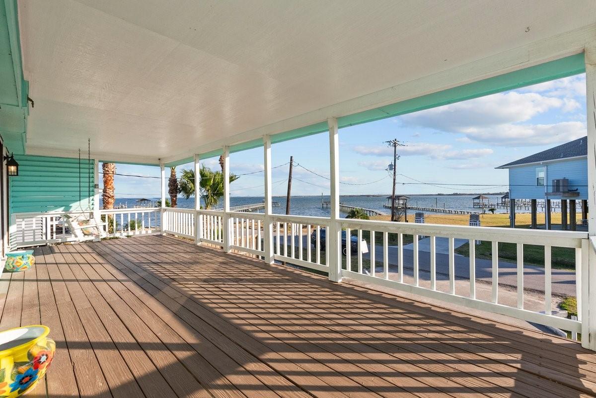 Image 2: Spacious covered porch with bay views, perfect for