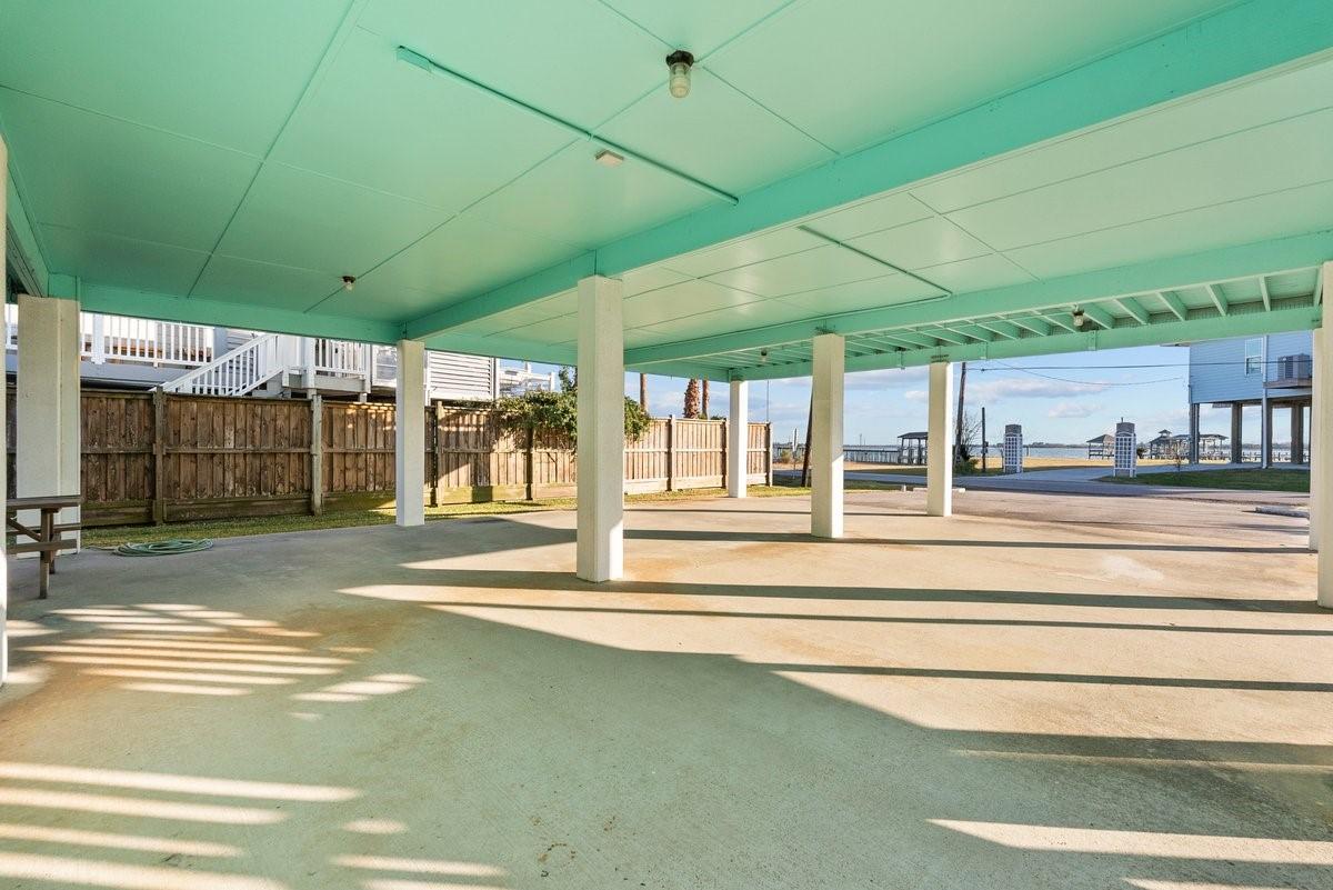 Image 4: Spacious covered carport featuring sturdy support