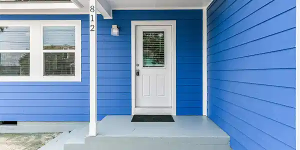 Image 2: The front door is bright and inviting complemented