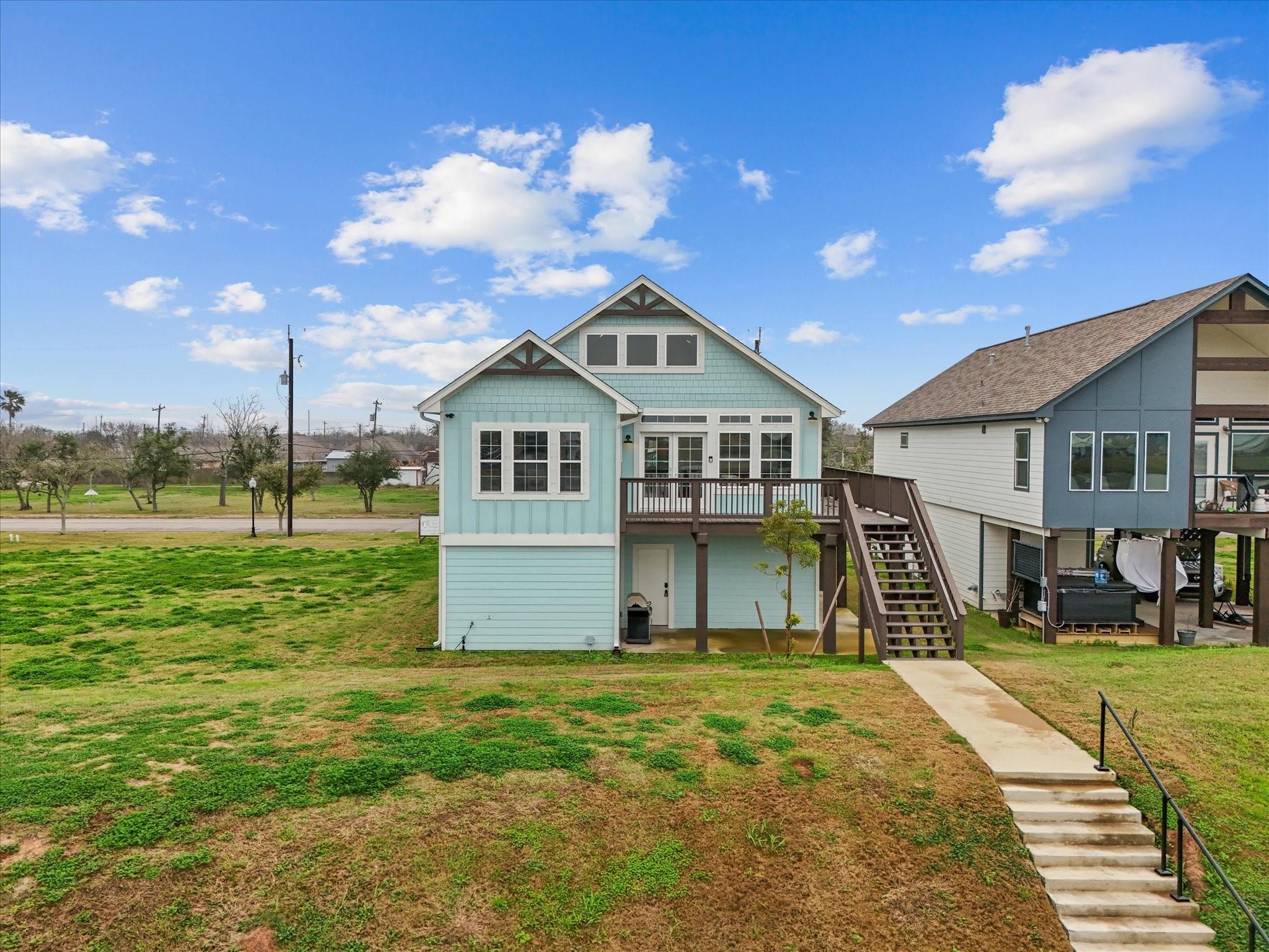 Image 4: This charming elevated home features a light blue