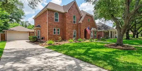 Image 2: Charming two-story red brick home with a detached