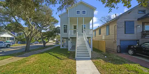 Image 3: Charming elevated home with a welcoming front stai