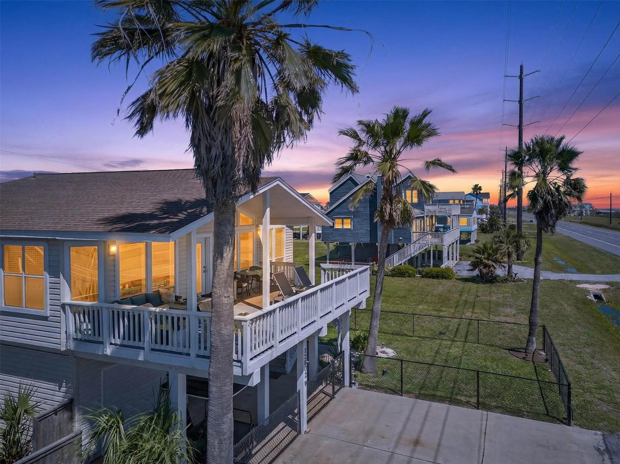 Image 1: Front left side of home at sunset