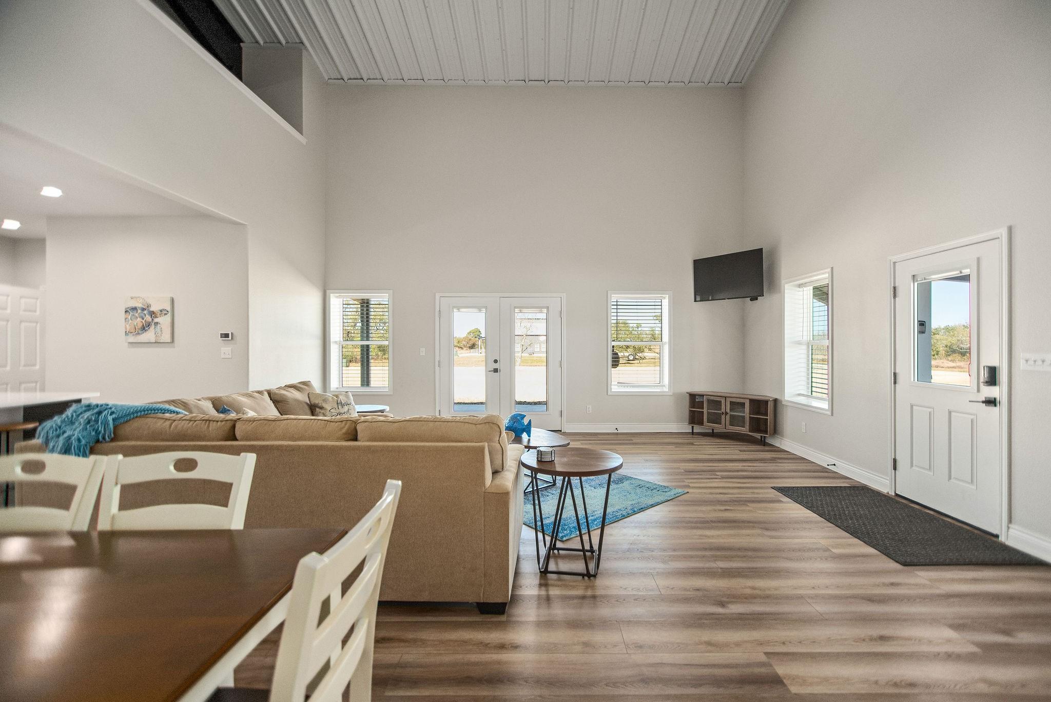 Image 4: Living and Dining Area with Double Doors to the Wr