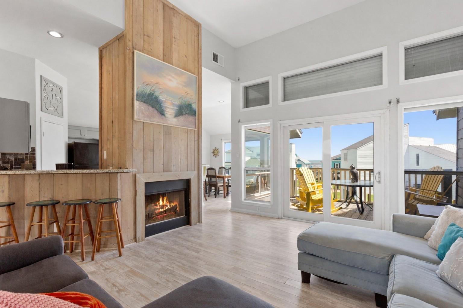 Image 1: Open living room features wall of windows with stu