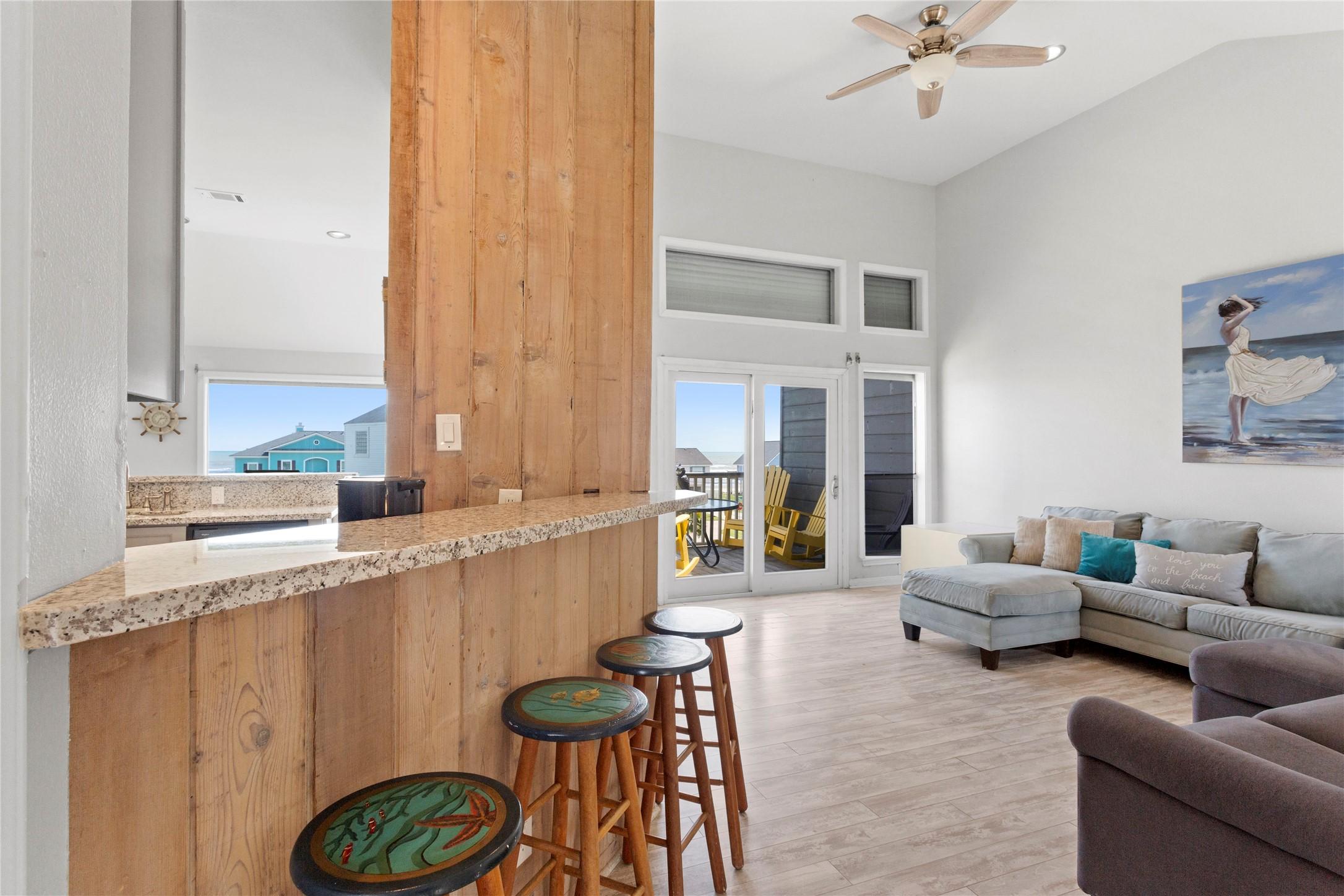Image 3: Cozy bar area opens to roomy living space with wal