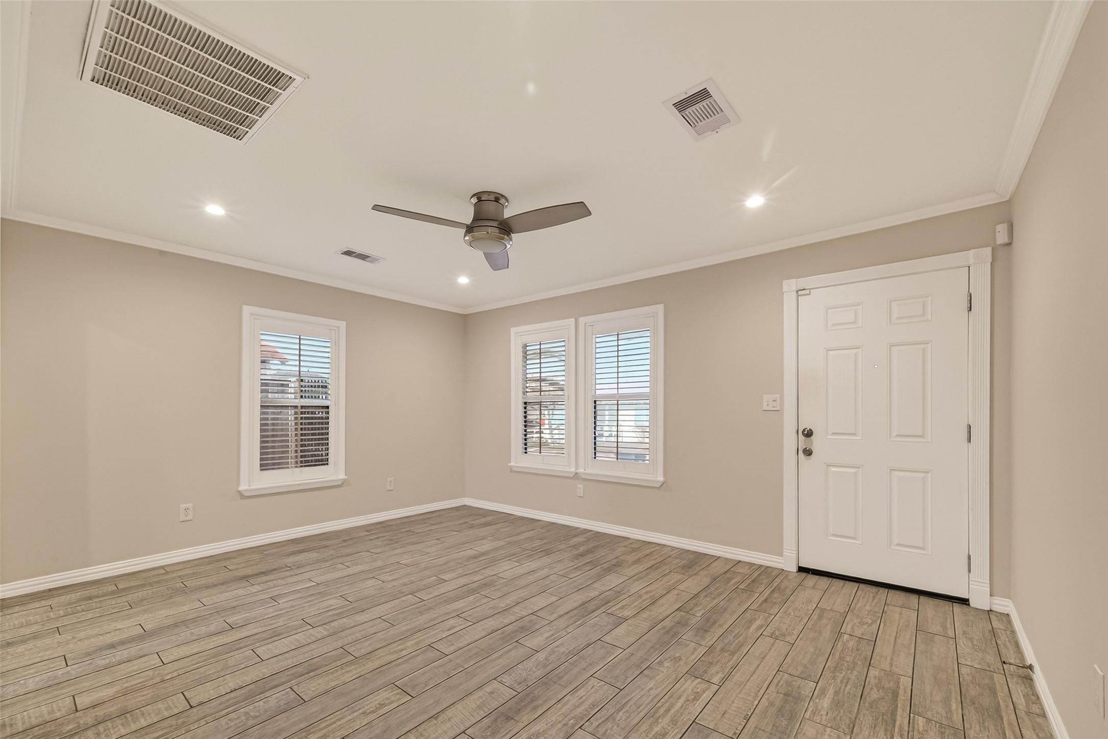 Image 4: The spacious main living area featuring wide-plank