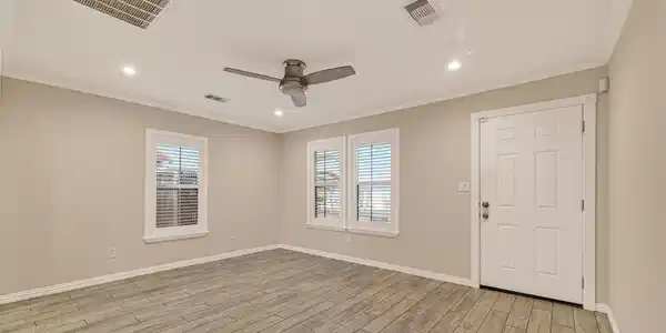 Image 4: The spacious main living area featuring wide-plank