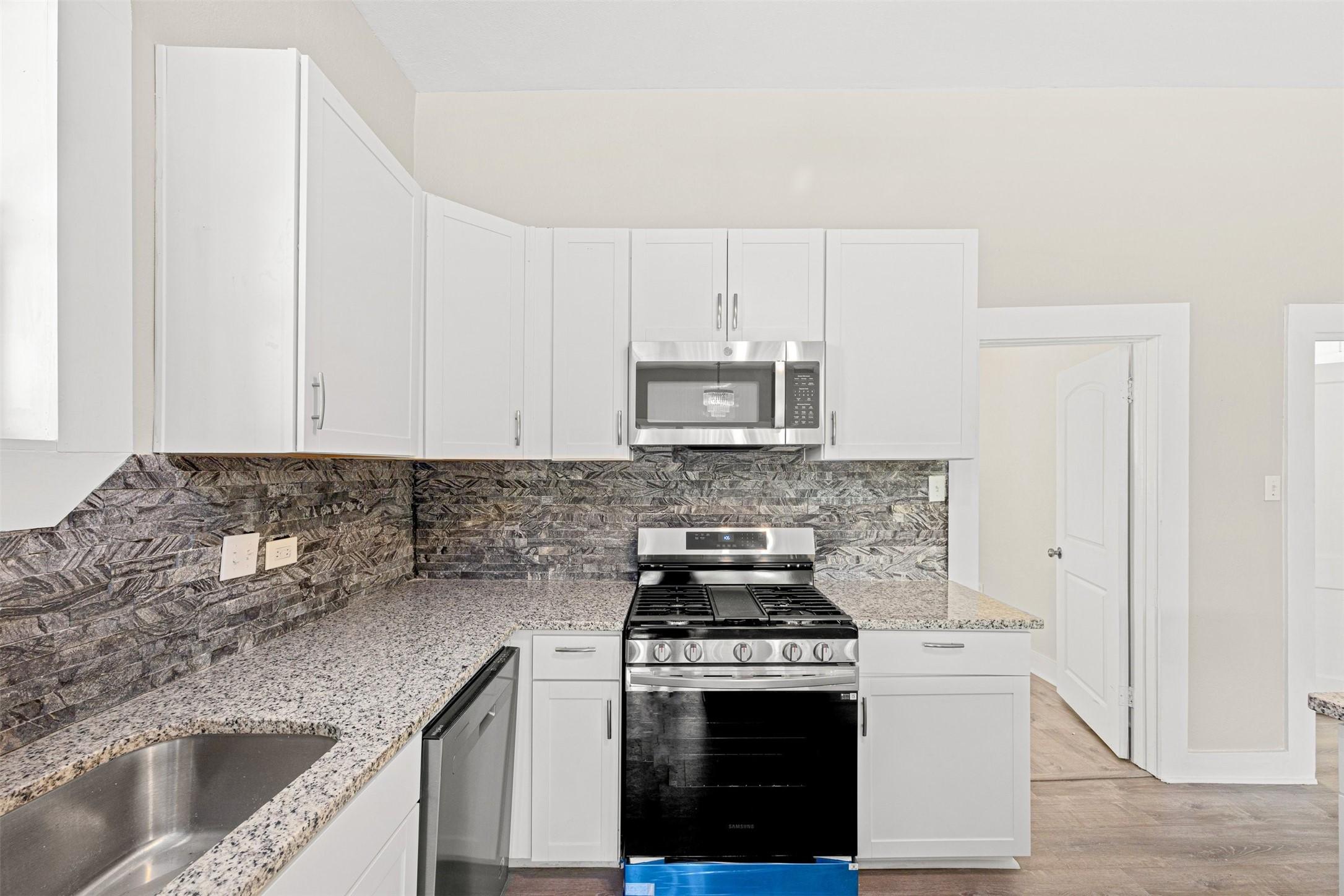 Image 4: this stunning kitchen showcases updated white cabi
