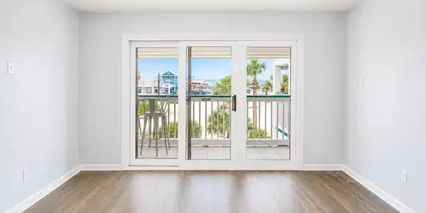 Image 3: Bright and airy room with sliding glass doors open