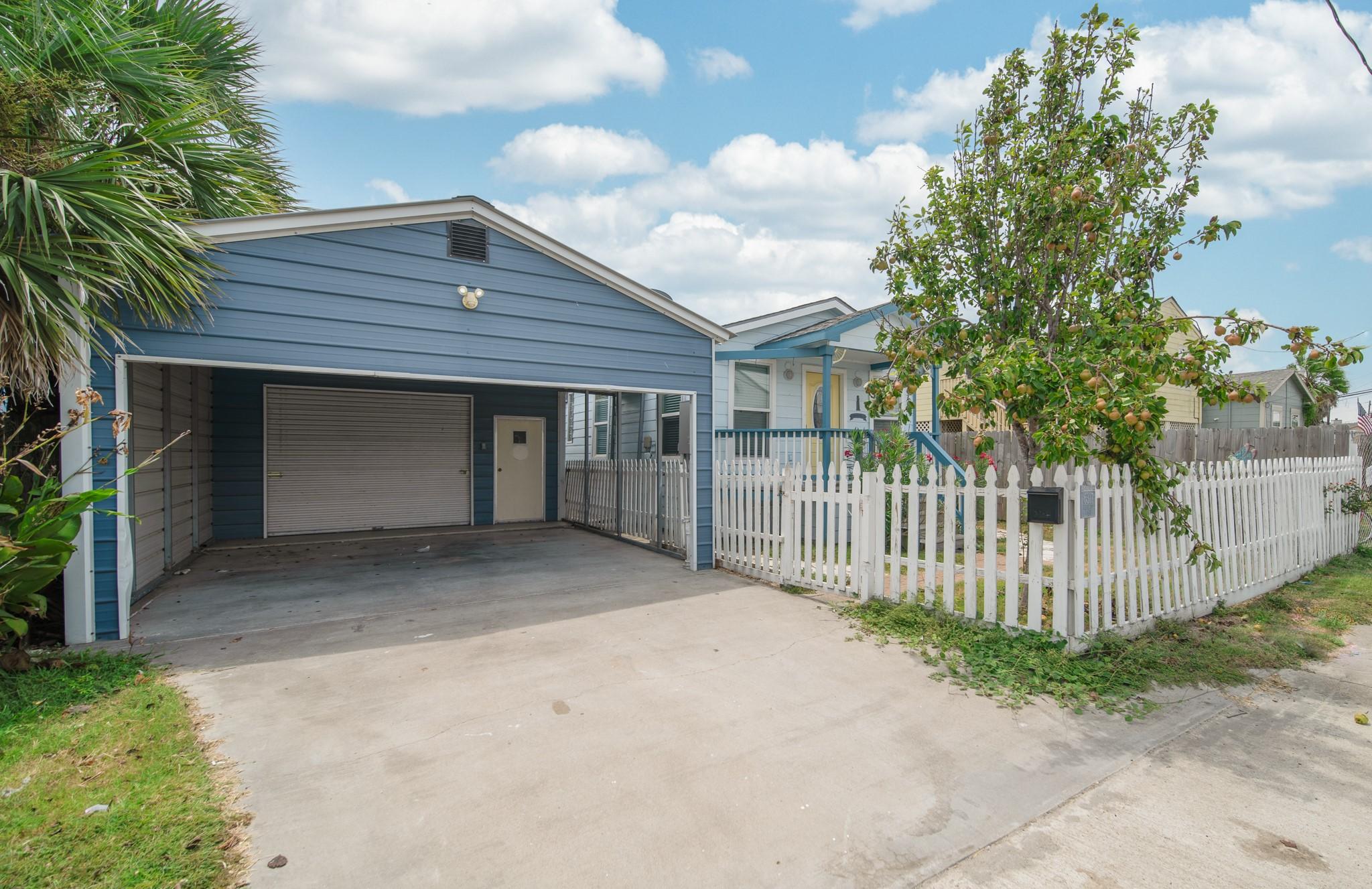 Image 3: A view of the covered carport and gated driveway,