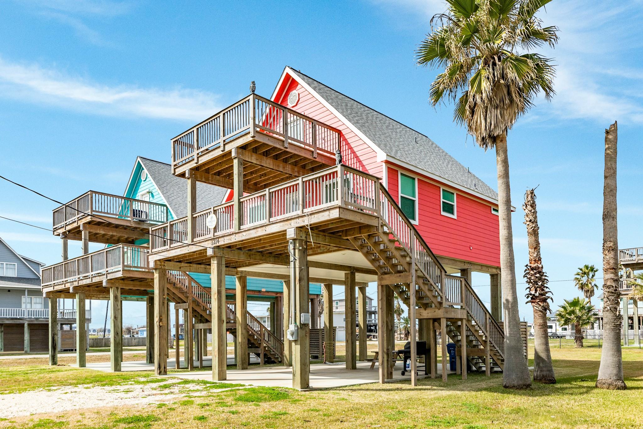 Image 3: Charming elevated beach house with vibrant exterio