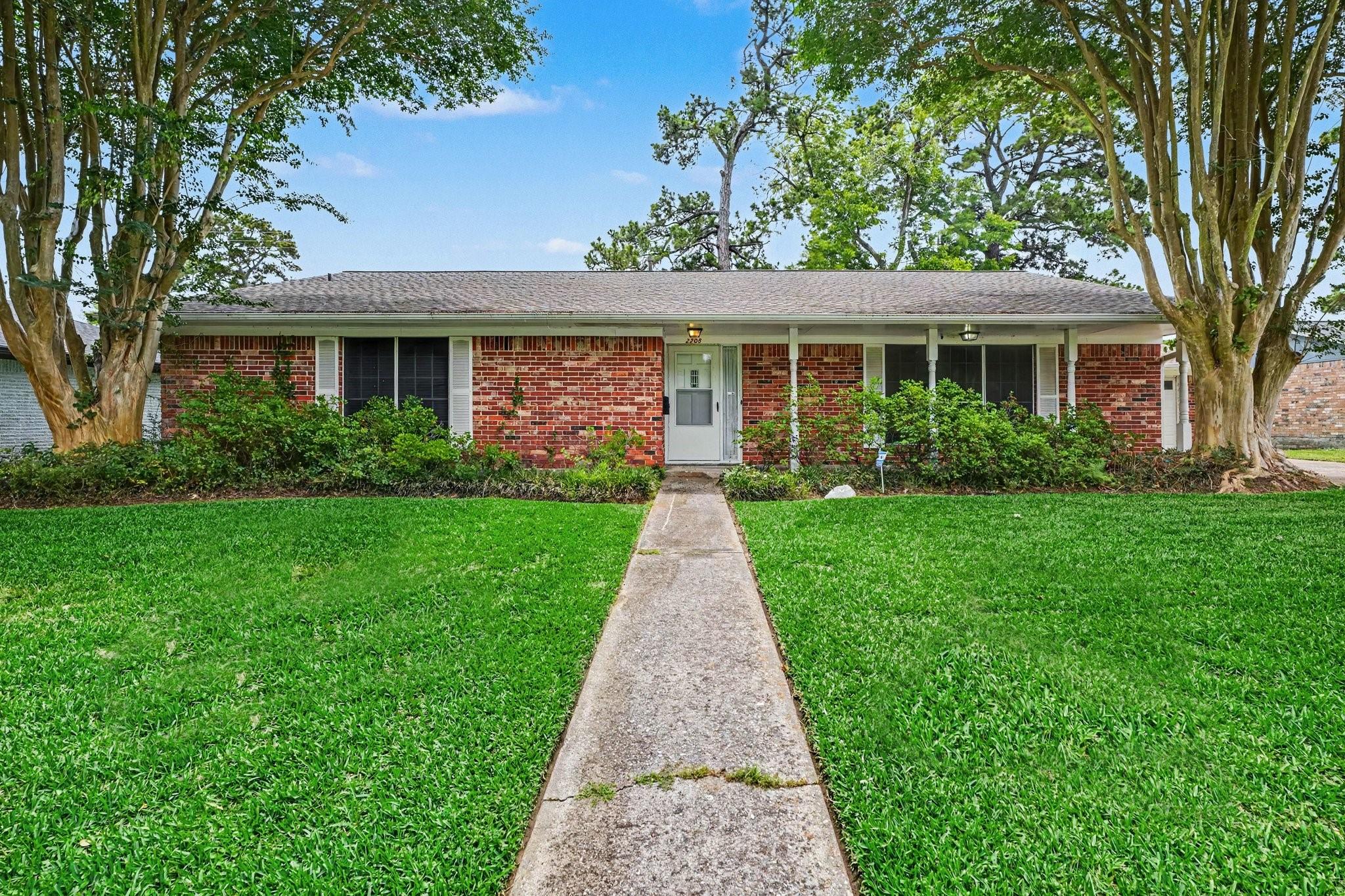 Image 2: Charming single-story brick home with a welcoming