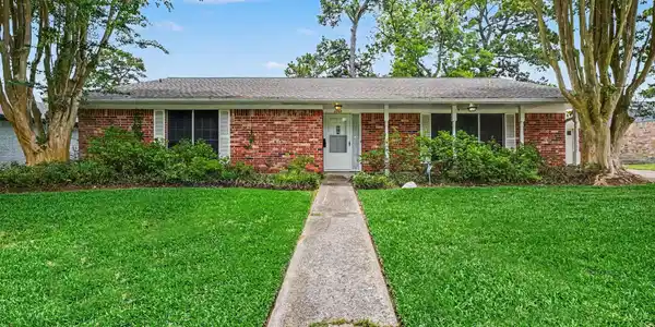 Image 2: Charming single-story brick home with a welcoming