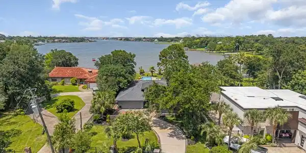 Image 4: Stunning lakefront property featuring lush greener