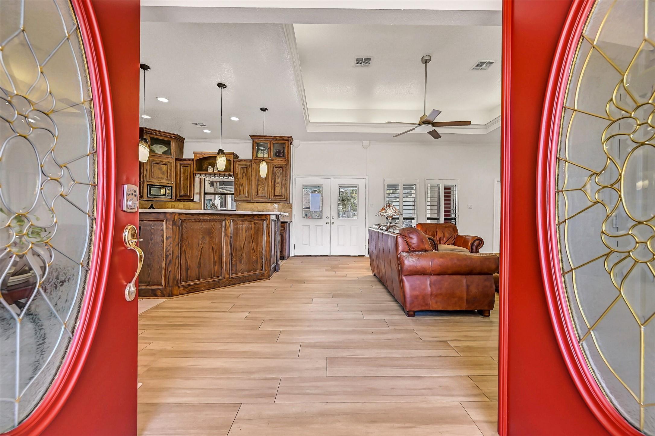 Image 4: The bold red double front doors open to reveal the