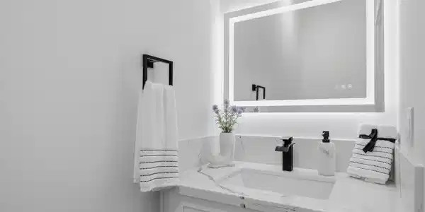 Image 3: Stylish half bath on the first floor featuring an