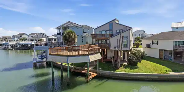 Image 3: Private canal frontage featuring a solid concrete