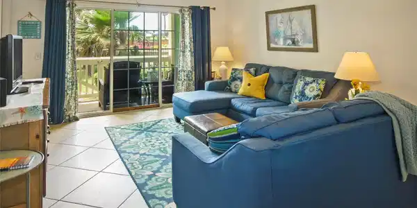 Image 2: Living room looks out to patio and front green spa