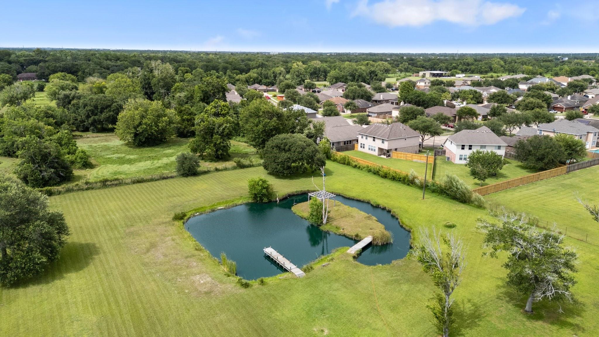 Image 2: Private, stocked catfish pond with a dock.