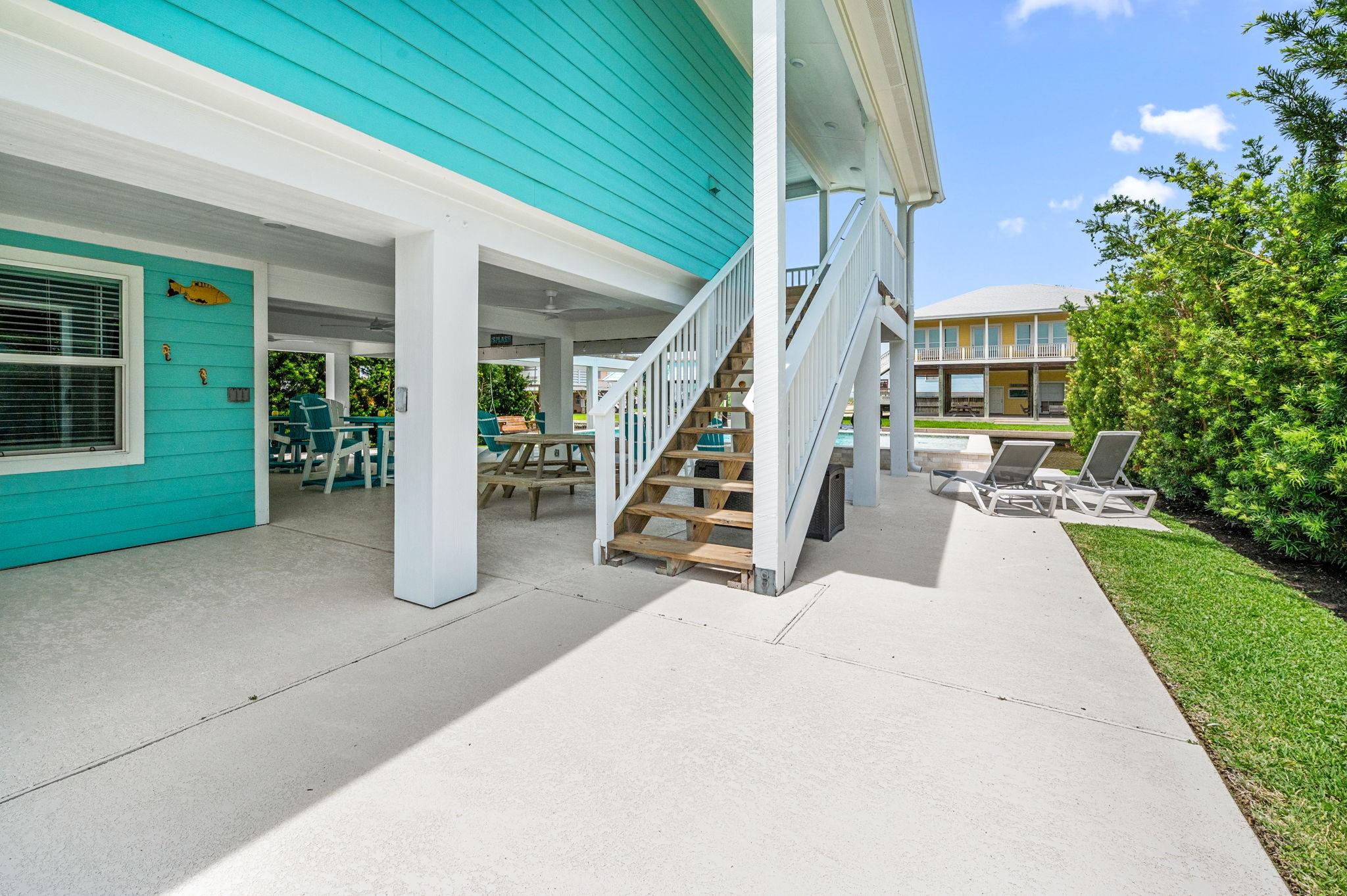 Image 4: The ground level features a spacious covered patio