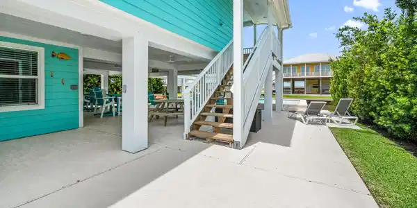 Image 4: The ground level features a spacious covered patio