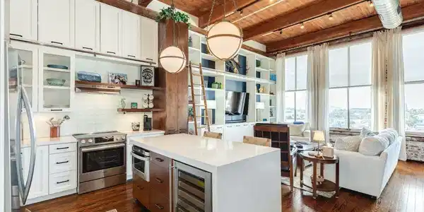 Image 3: Open concept kitchen and living area with exposed