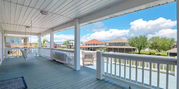 Image 4: Balconies on front and back of the home.  Two swin