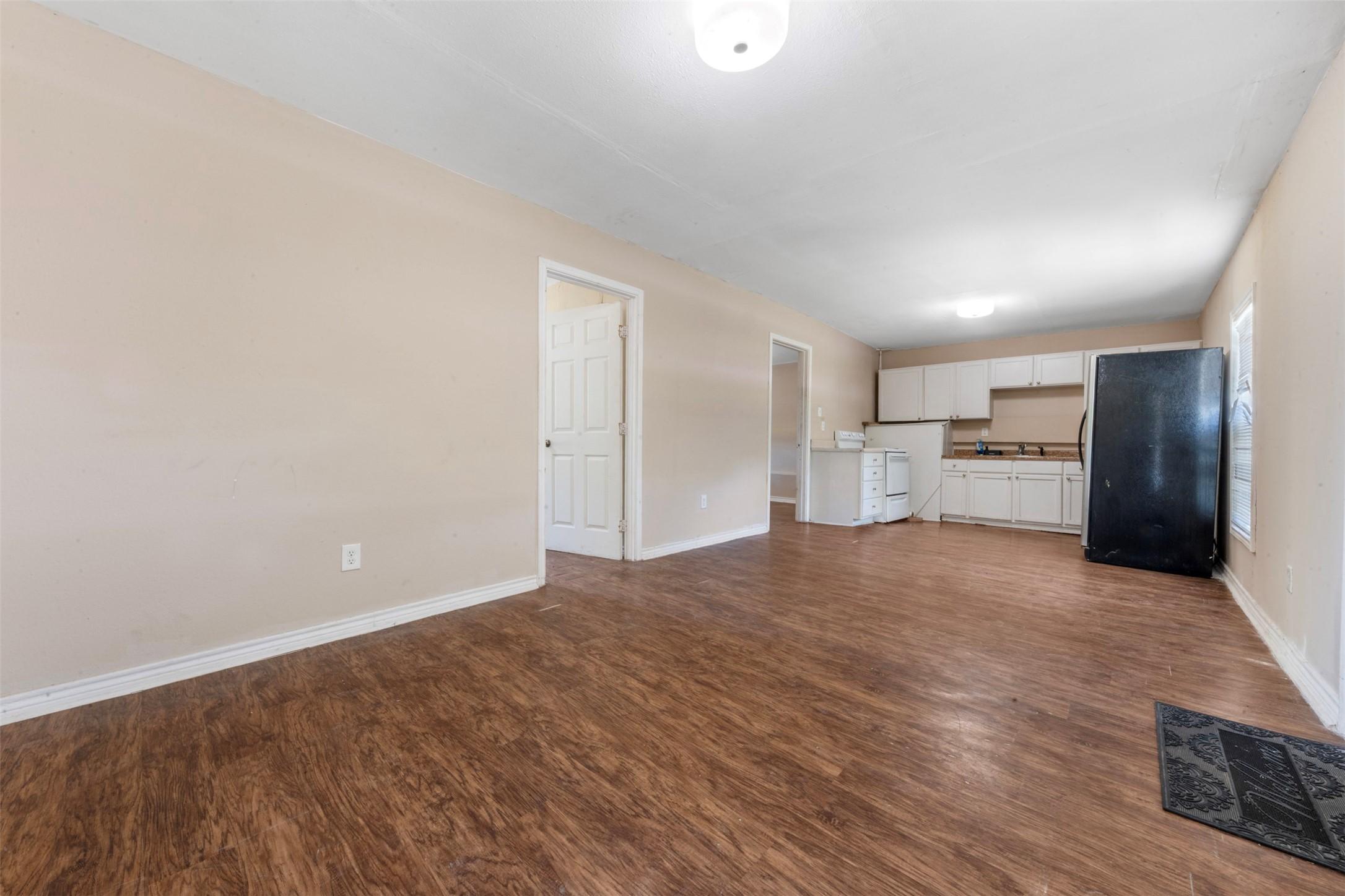 Image 3: view of kitchen from the living area.