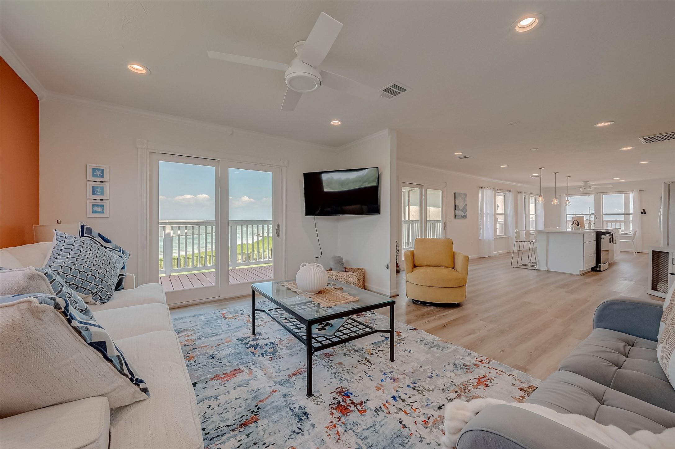 Image 3: Comfortable living room with direct deck access, w