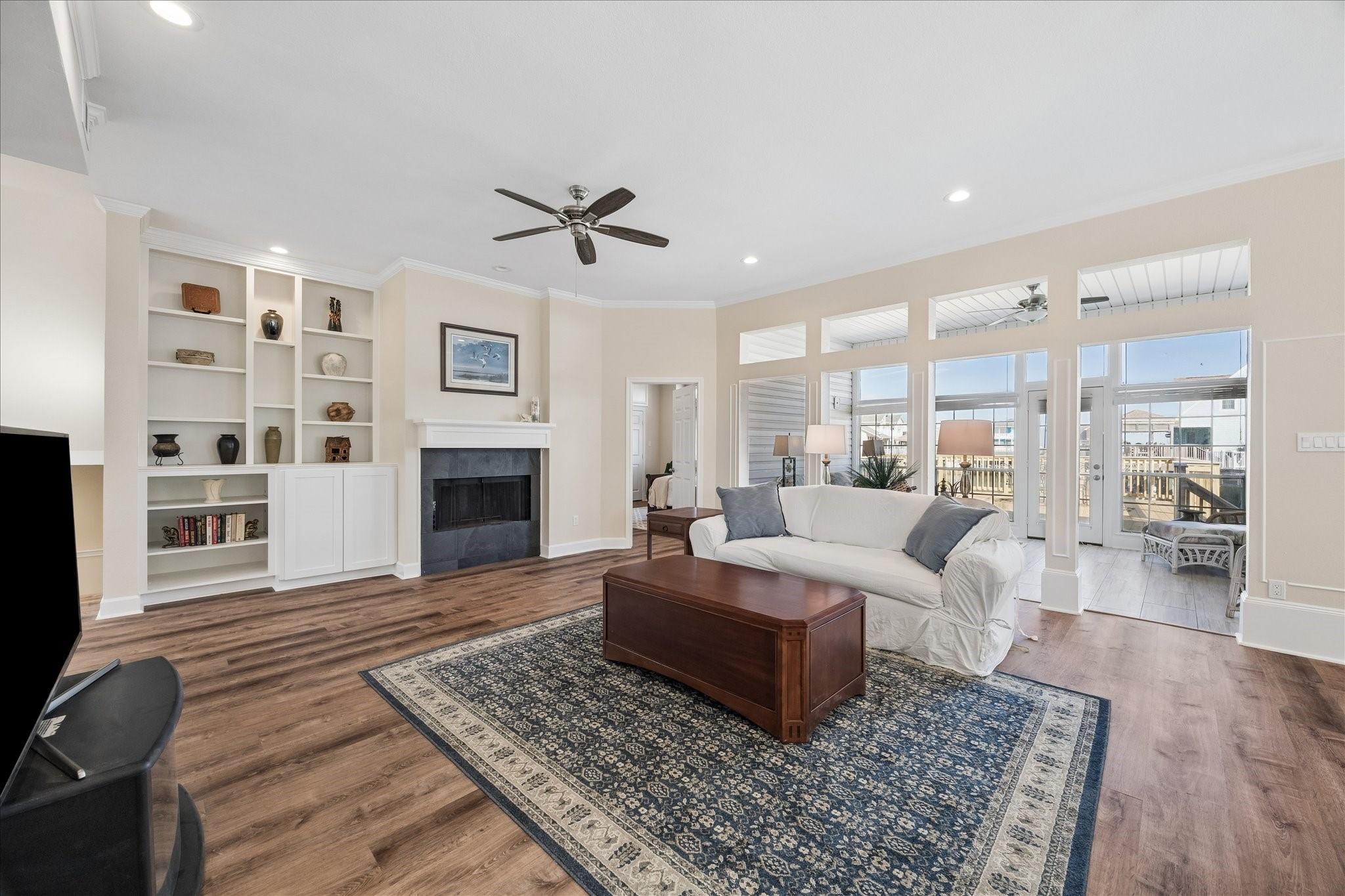 Image 2: This spacious living room features a cozy fireplac