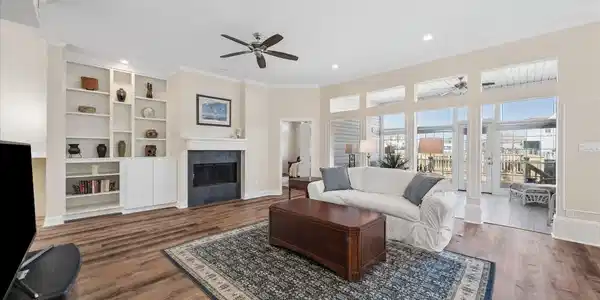 Image 2: This spacious living room features a cozy fireplac