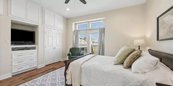 Image 4: This cozy bedroom features a large window for natu