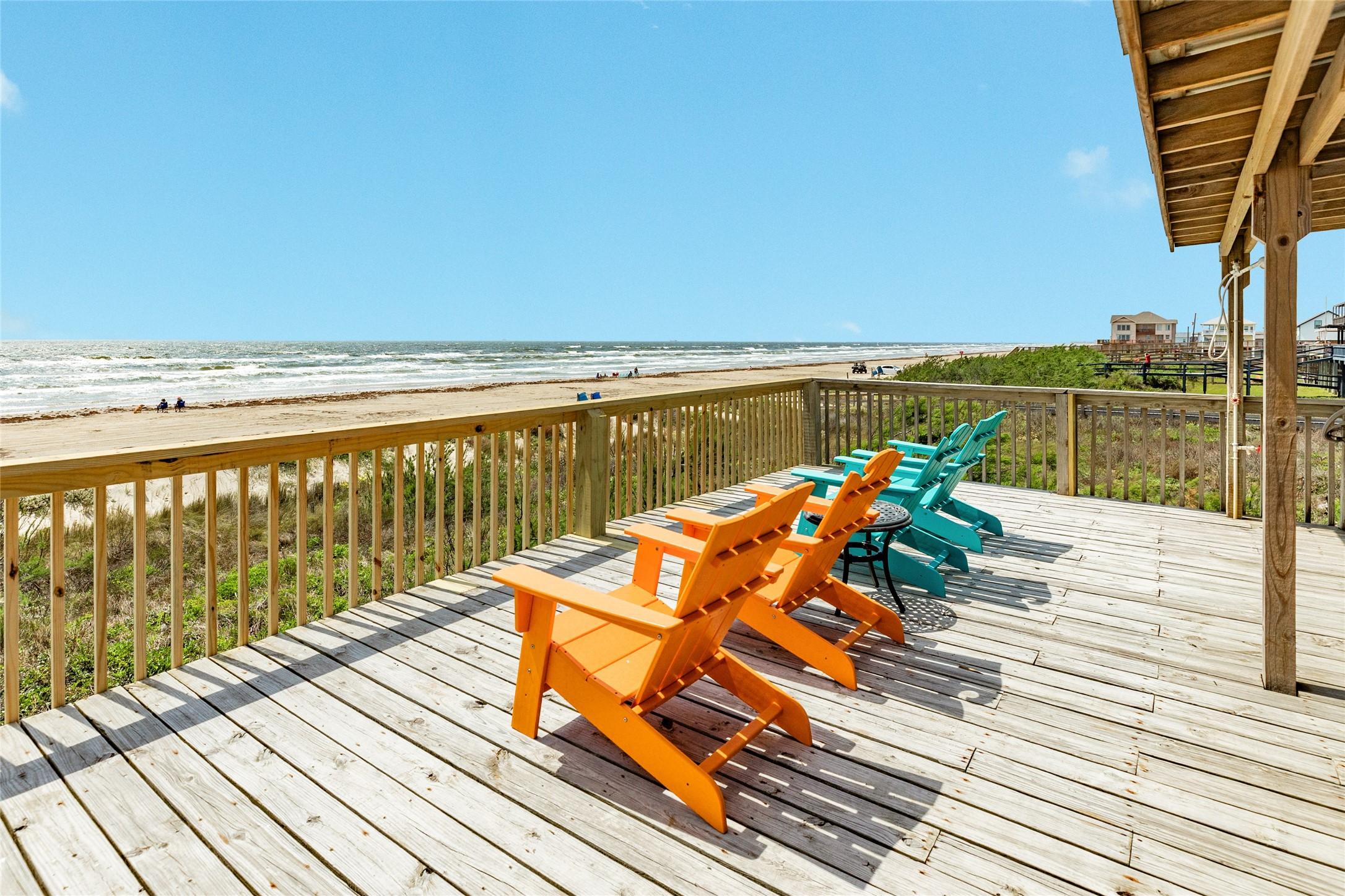 Image 2: Spacious beachfront deck with Adirondack seating o