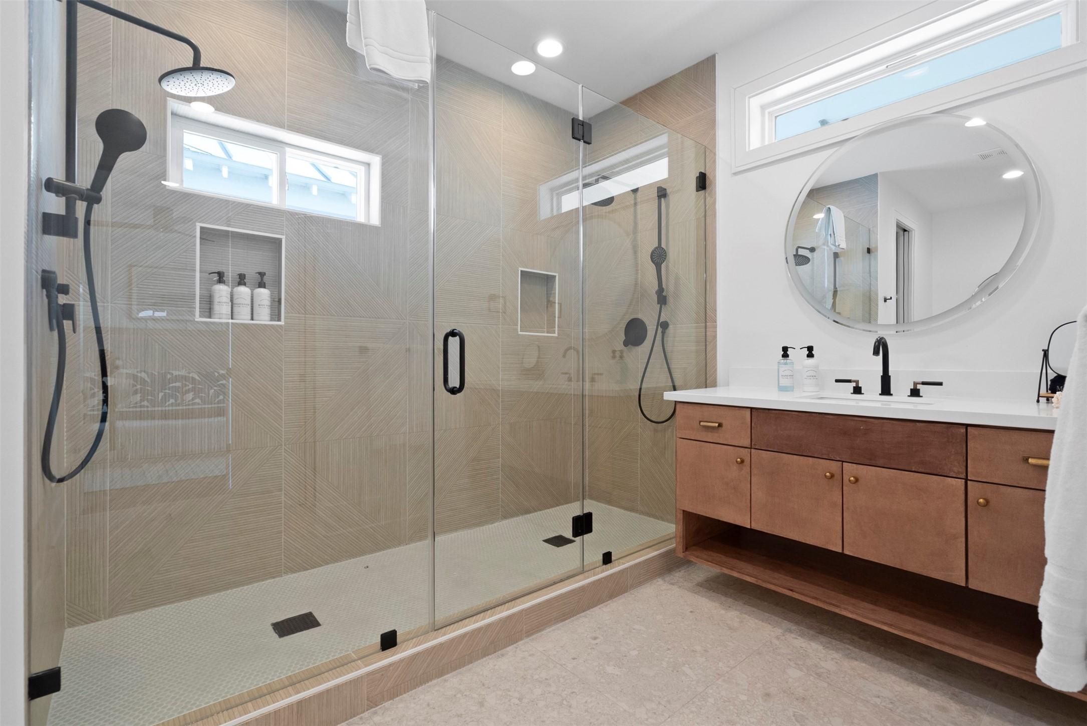 Image 4: The primary bath is a SPACIOUS, spa-inspired retre