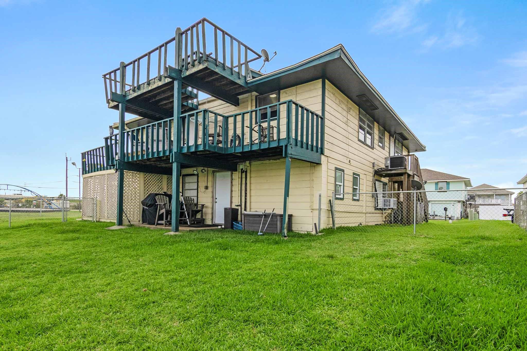 Image 3: Canal side of home showing deck on second floor an