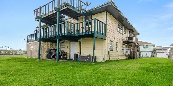 Image 3: Canal side of home showing deck on second floor an