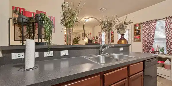 Image 4: Ample and modern kitchen with warm wooden cabinets