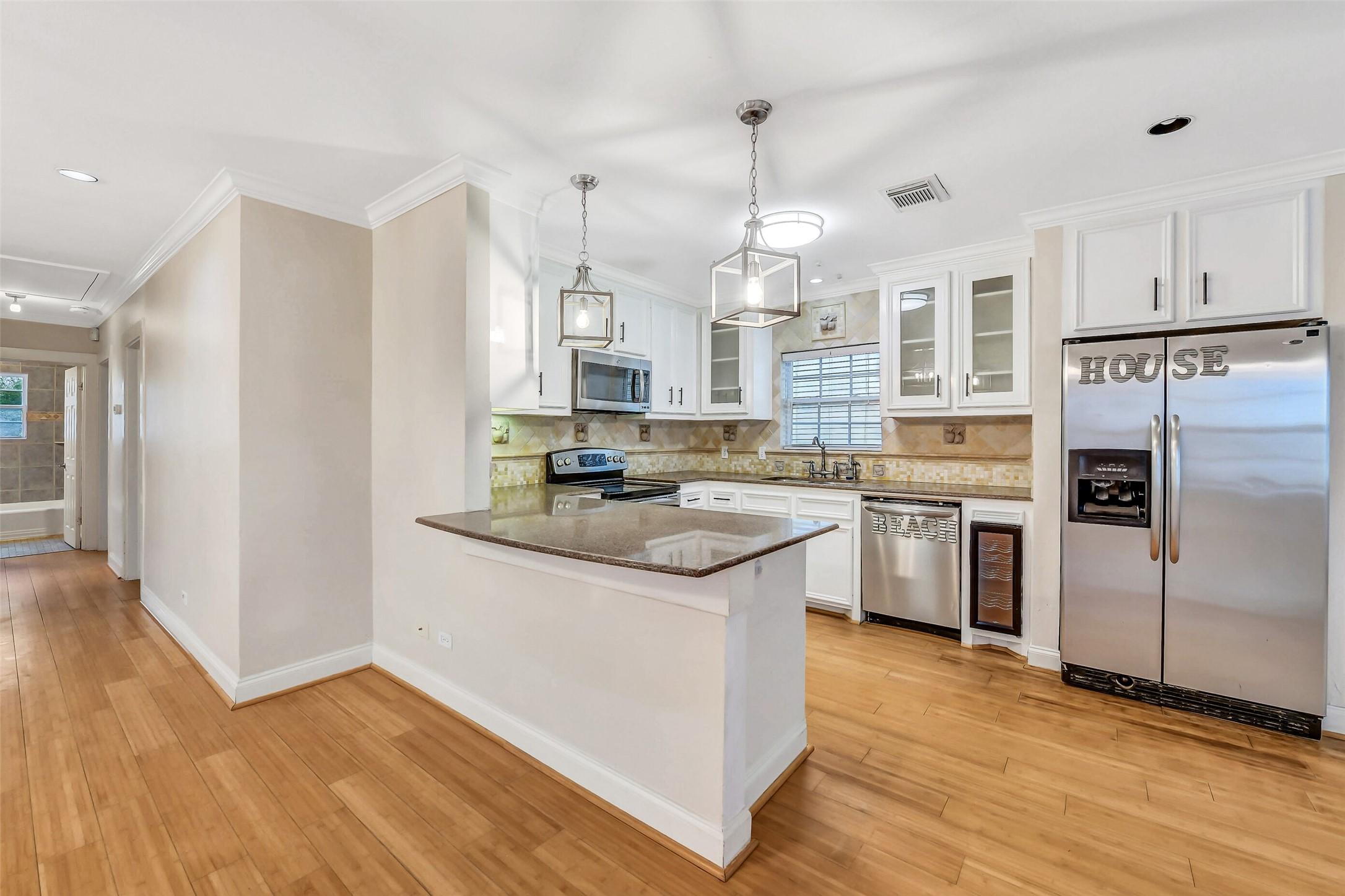 Image 3: Open-concept kitchen designed for connection, feat