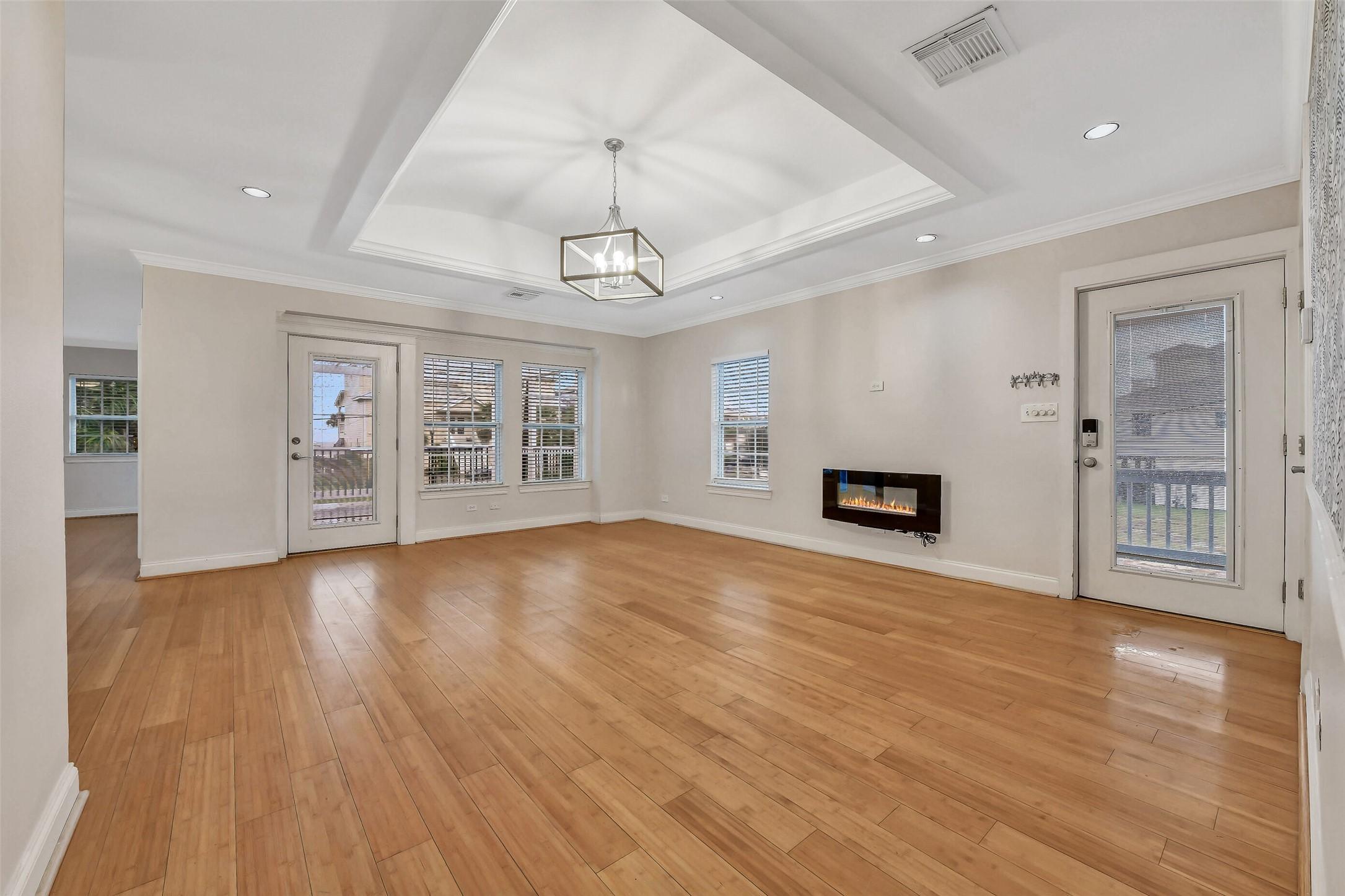 Image 4: Light-filled living area anchored by an electric f