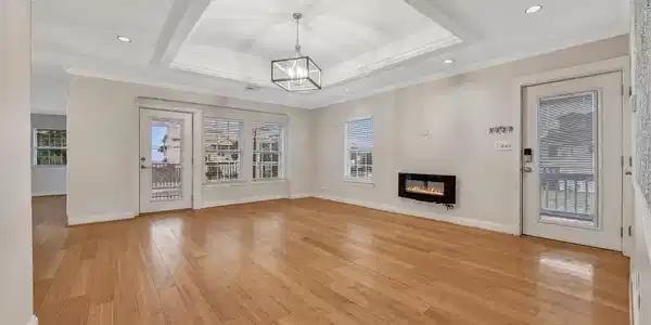 Image 4: Light-filled living area anchored by an electric f