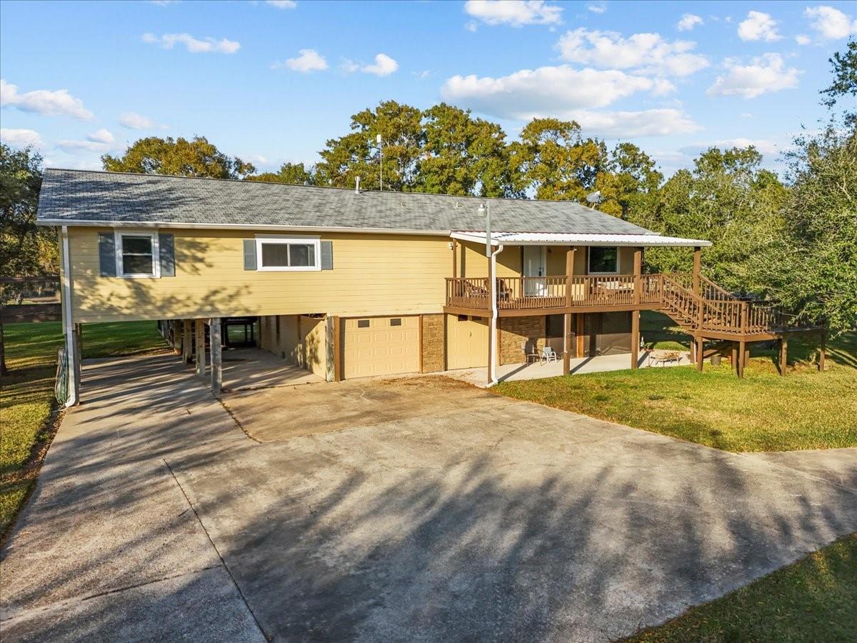 Image 3: This photo shows a raised, two-story home with a s