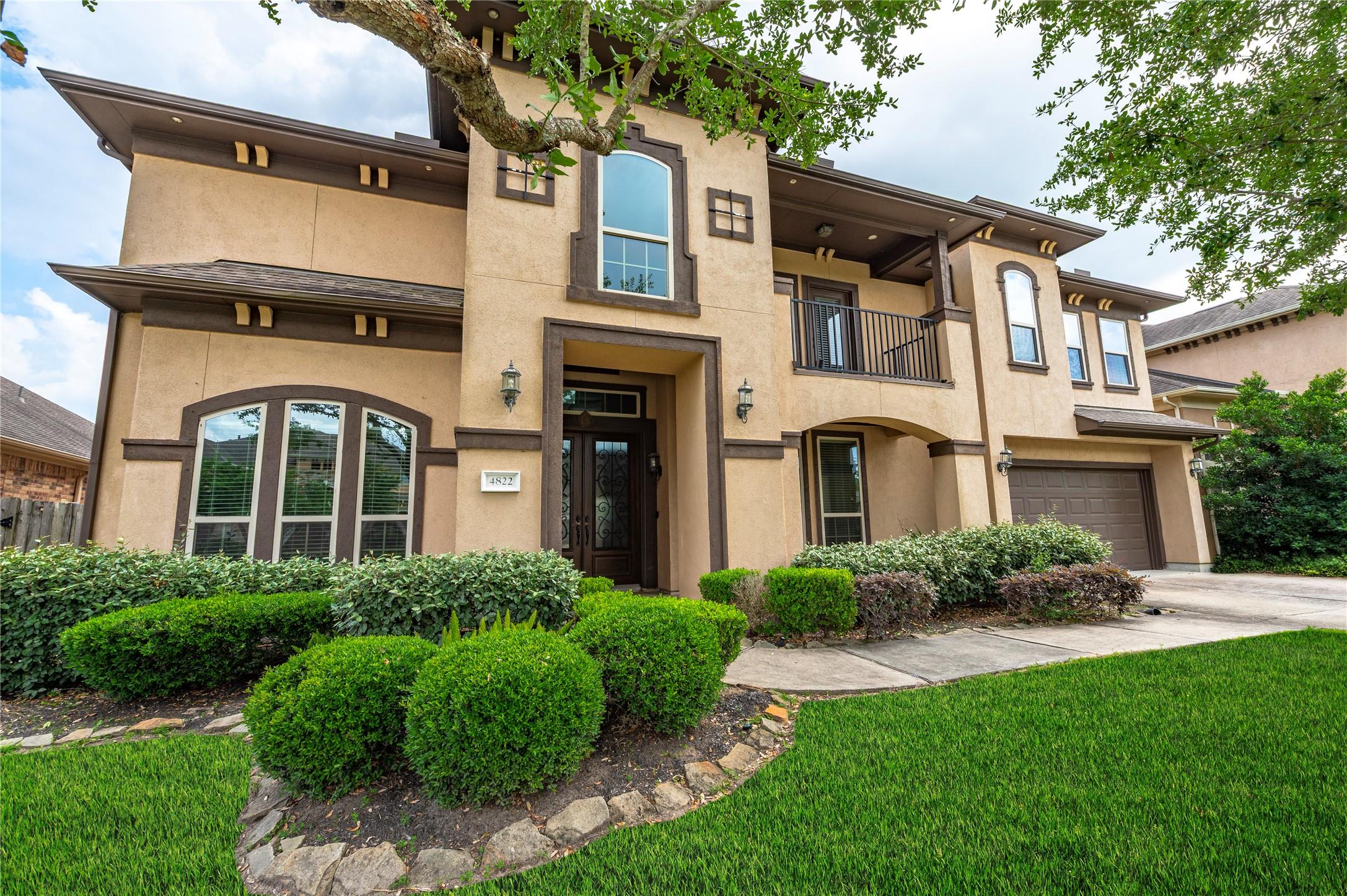 Image 3: Another view of the two story home with stucco ext