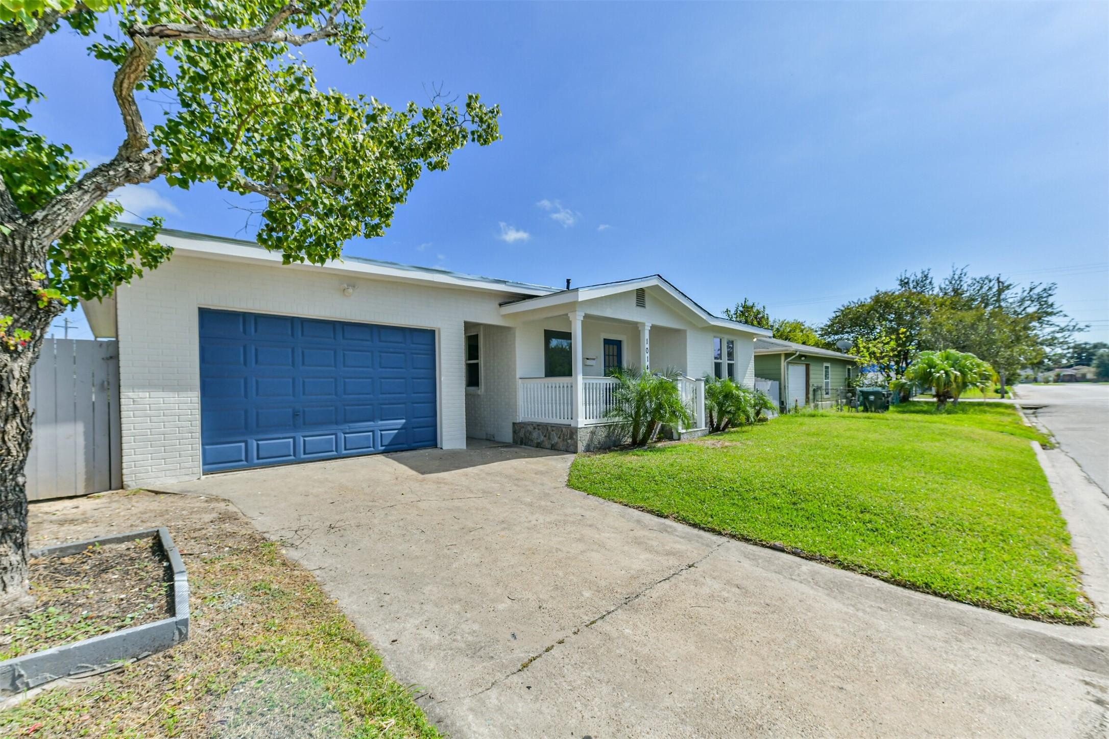 Image 2: This home features a double-wide driveway, offerin