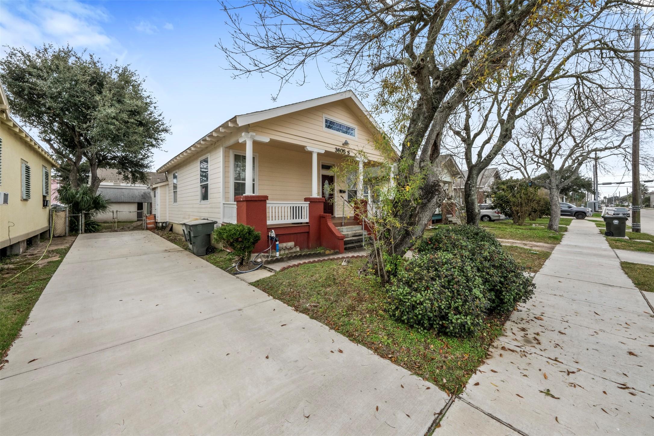 Image 2: Side view of home with a view of the driveway.