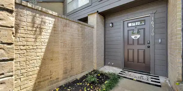 Image 2: Charming front entrance with a welcoming brown doo