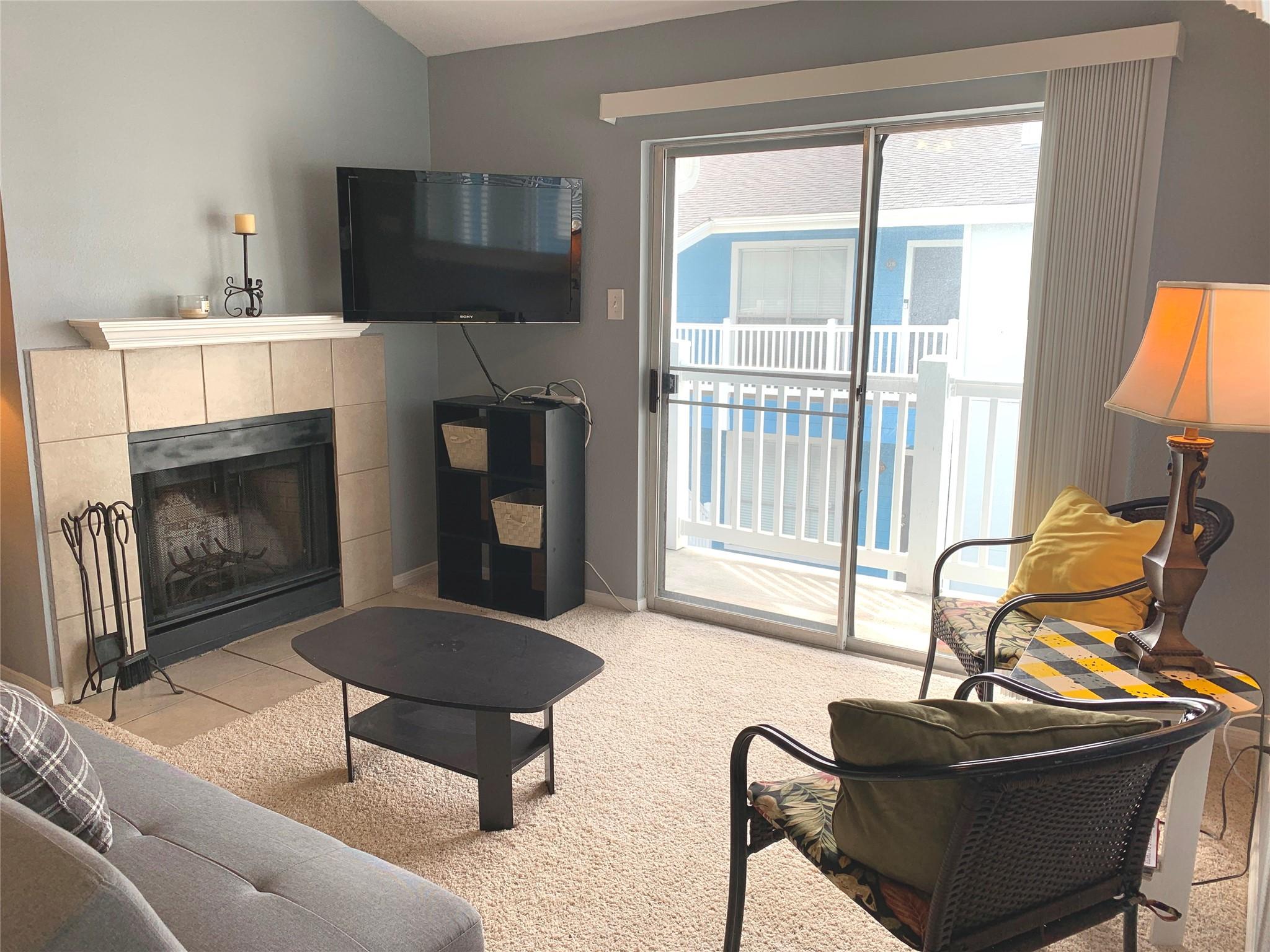 Image 3: Living room has access to a small balcony.
